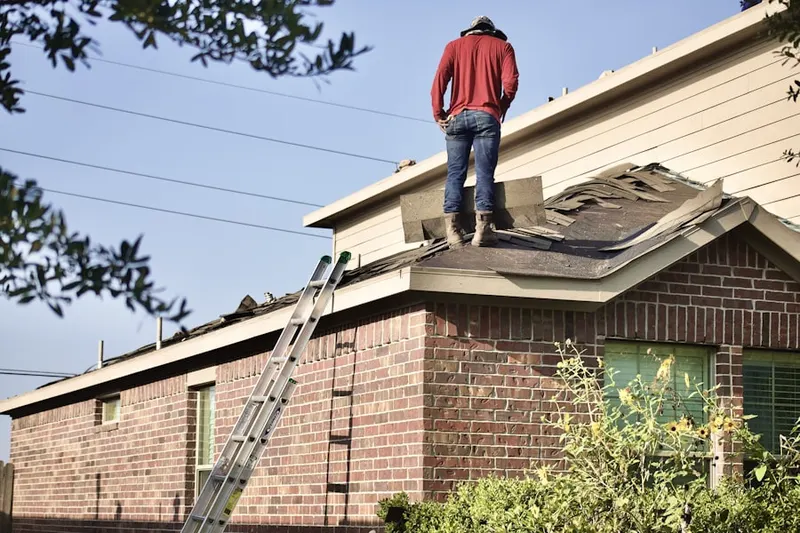 Professional roofer working on a residential roof in Whitemarsh Island
